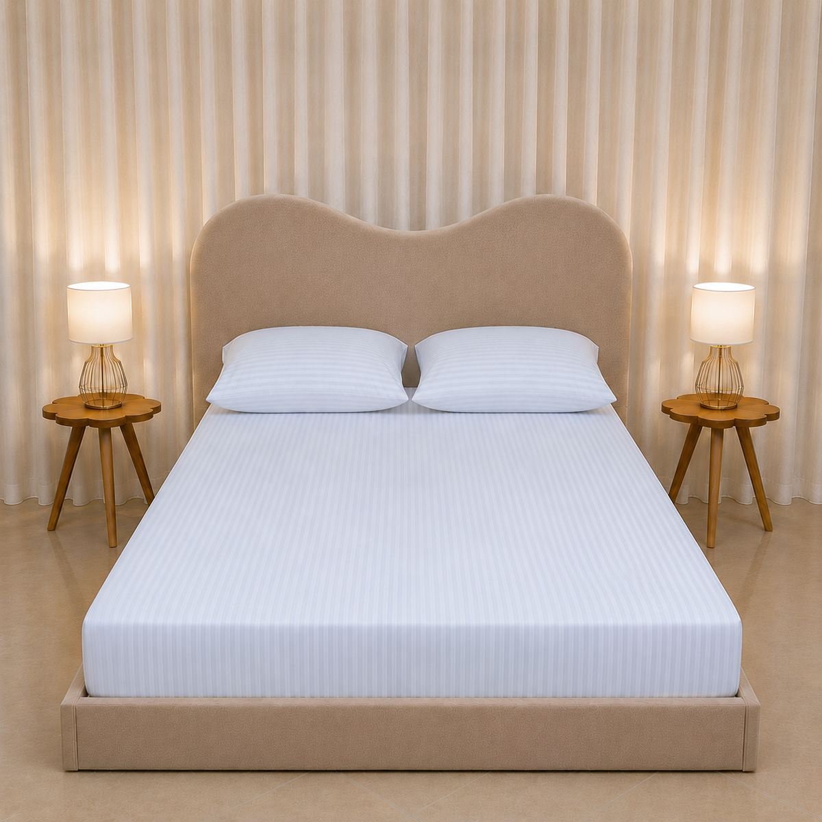 A neatly made bed with a white striped mattress cover and two white pillows, set in a modern bedroom with a beige upholstered headboard and footboard, flanked by two wooden side tables with lit lamps against a beige curtain backdrop.