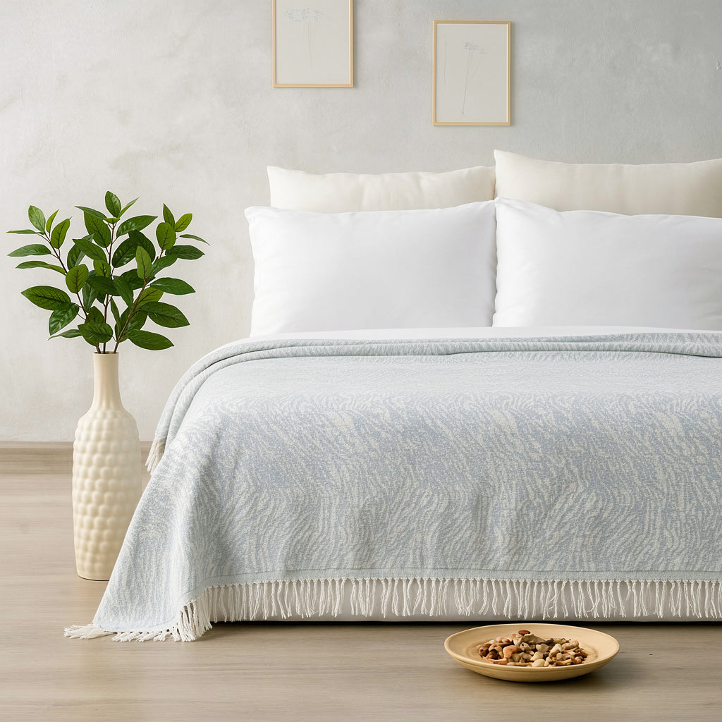 Neatly made bed with white bedding in a bedroom setting.